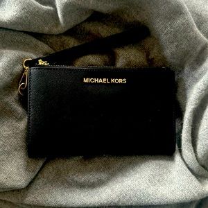 Like new black three part Michael Kors Wristlet with phone pocket